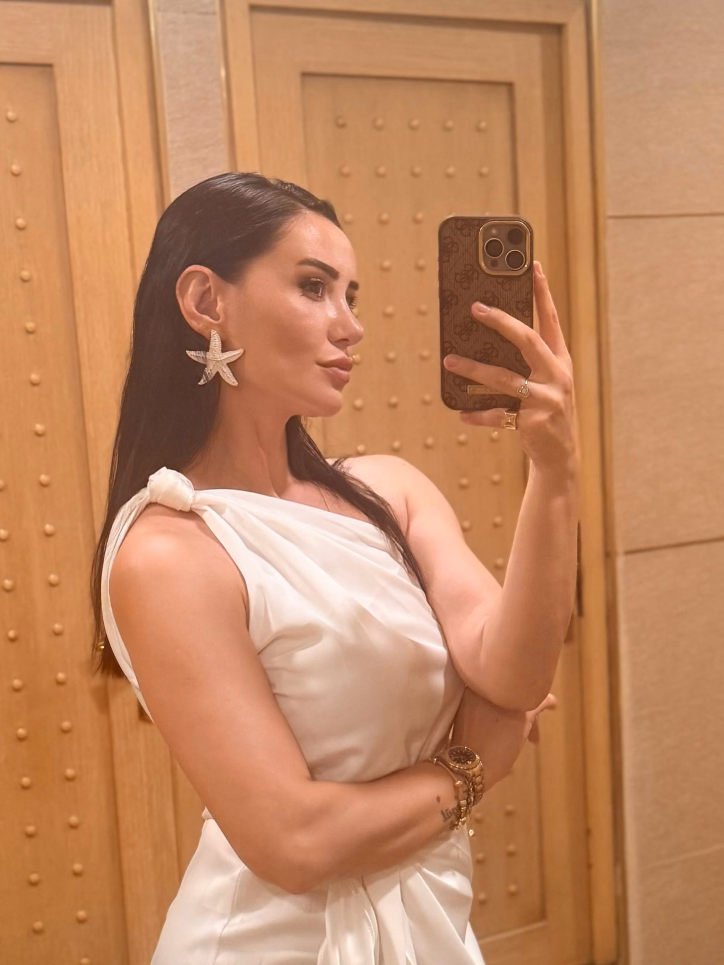 Patient taking a mirror selfie after rhinoplasty in Ankara, side profile