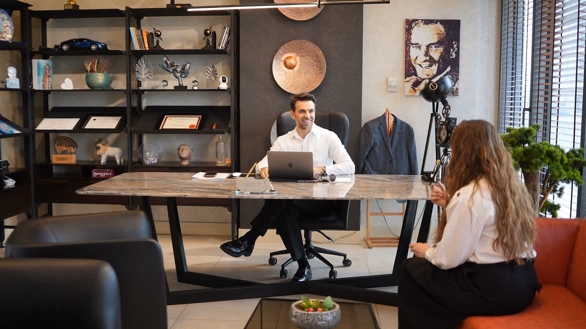 Op. Dr. Serdar Başer talking with a patient during a rhinoplasty consultation at his clinic in Ankara
